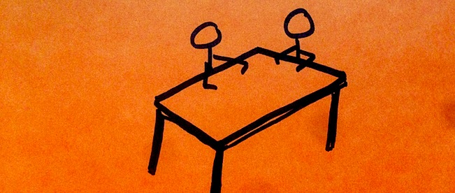 People sitting at right angles at a table